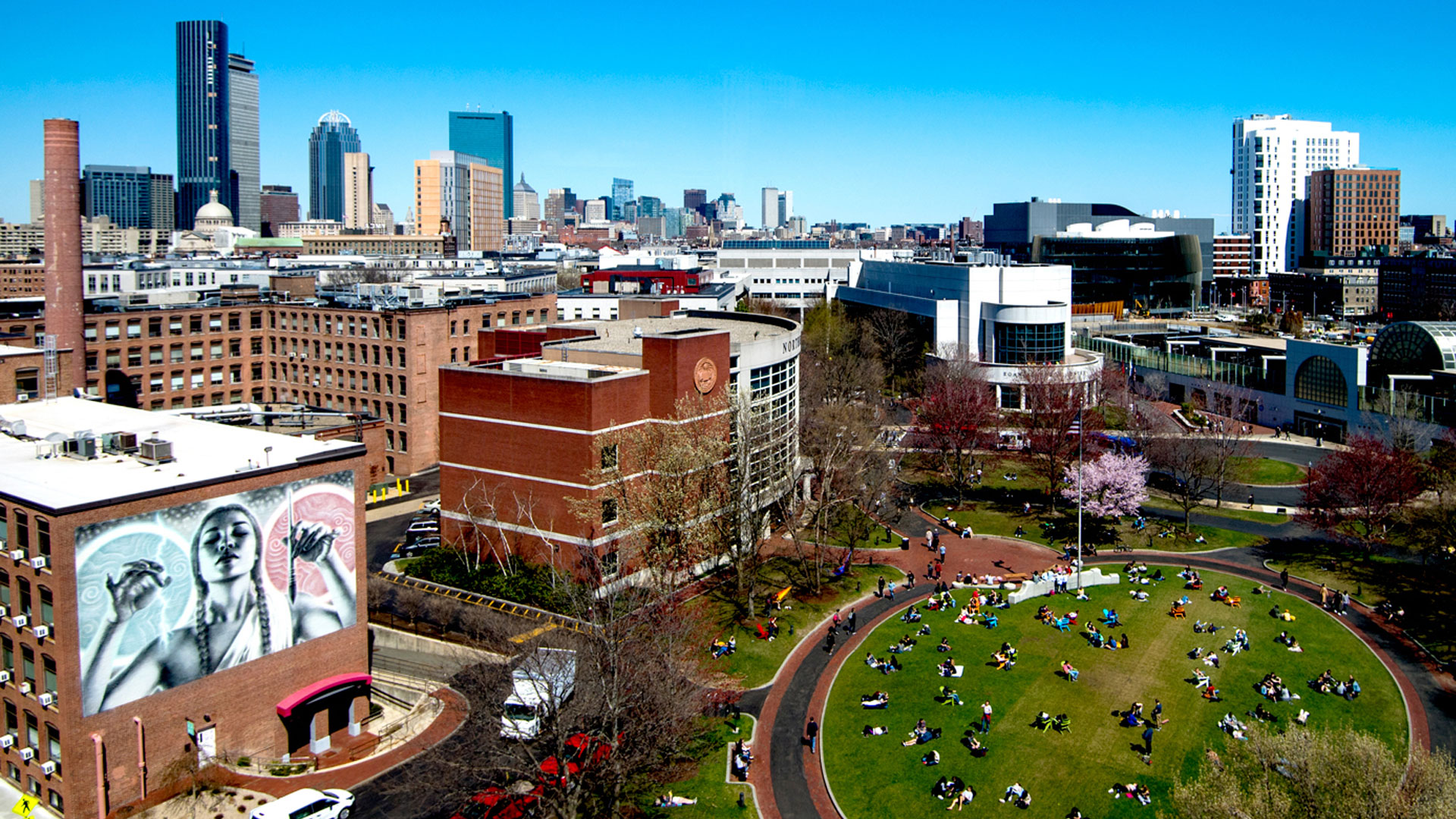 Urban campus with people enjoying outdoors.