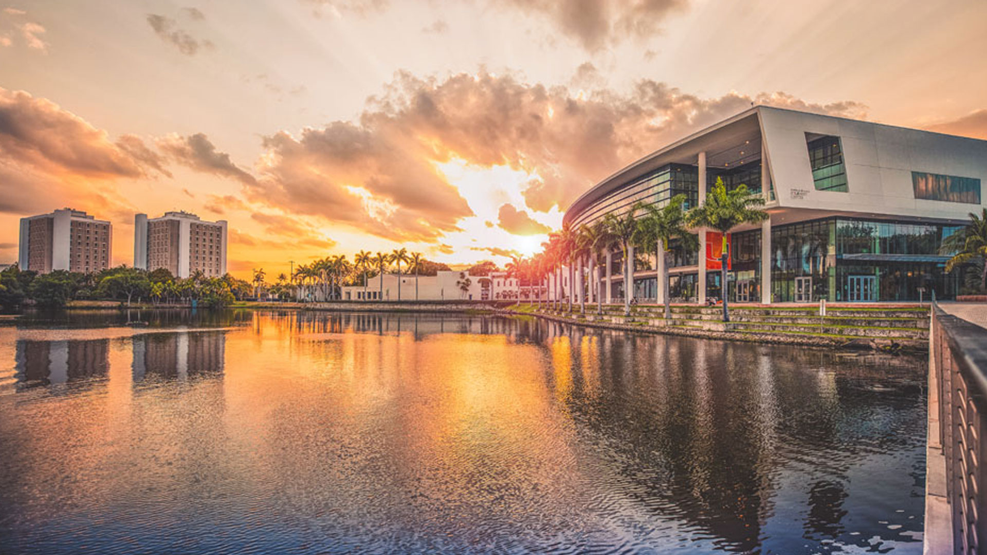 Sunset over lake and buildings.